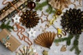 The process of preparing New Year`s decor from wrapping paper on a light wooden background with snowflakes, stars, ribbons. Layou Royalty Free Stock Photo