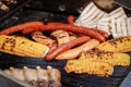Process of preparing sausages and corn on Outdoor Grill. Royalty Free Stock Photo