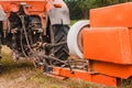The process of pressing hay into bales, the work of the press machine, the mechanism and details of the press Royalty Free Stock Photo