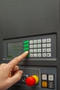 The process of programming a CNC machine. Entering data into a computer controlled machine. CNC machine operator enters Royalty Free Stock Photo