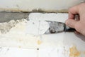 The process of putty of the old aged wall of the house