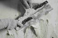 The process of removing old worn out unattractive green from the wall with the help of available tools and a spatula, hands, Royalty Free Stock Photo