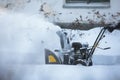 Process of removing snow with portable blower machine, worker dressed in overall workwear with gas snow blower removal on the