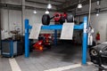 The process of repairing and restoring a red Ferrari Formula 1 car at a pitstop in the service station or a repair workshop on a