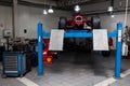 The process of repairing and restoring a red Ferrari Formula 1 car at a pitstop in the service station or a repair workshop on a