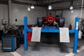 The process of repairing and restoring a red Ferrari Formula 1 car at a pitstop in the service station or a repair workshop on a Royalty Free Stock Photo