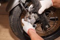 The process of replacing brake pads on a motorcycle
