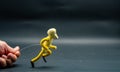 Process of running stopmotion. Start of running. Man\'s hand holding with aluminum wire a figure created with modeling paste. Royalty Free Stock Photo