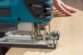 The process of sawing a wooden board with a jigsaw by handyman Royalty Free Stock Photo