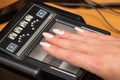 The process of scanning fingerprints during the check at border crossing. Female hand puts fingers to the fingerprint scanner.