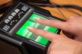 The process of scanning fingerprints during the check at border crossing. Female hand puts fingers to the fingerprint scanner.