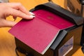 The process of scanning a German biometric passport to register the fact of crossing the state border. Female hand puts a passport