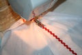 The process of sewing a red ribbon to a white fabric Royalty Free Stock Photo