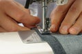 Process of shortening jeans pants on a sewing machine