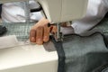 Process of shortening jeans pants on a sewing machine