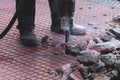 Process of sidewalk road repairing with jackhammer, builder worker Royalty Free Stock Photo