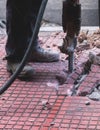 Process of sidewalk road repairing with jackhammer, builder worker Royalty Free Stock Photo