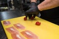The process of slicing fresh cherry tomatoes.