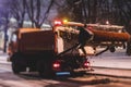 Process of snow removal on the city streets and roads with municipal vehicle, bulldozer, snowblower plow truck, snowplow, snow