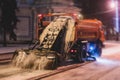 Process of snow removal on the city streets and roads with municipal vehicle, bulldozer, snowblower plow truck, snowplow, snow