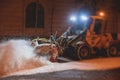 Process of snow removal on the city streets and roads with municipal vehicle, bulldozer, snowblower plow truck, snowplow, snow