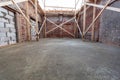 Process of solidification of concrete floor after pouring and reinforcement of load-bearing walls with wooden beams on the