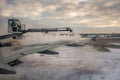 A process of spraying anti-icing white fluid the rear part of the wing of a plane at the airport at sunrise in winter on the blue