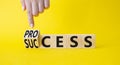 Process and Success symbol. Businessman Hand points at turned cube with words success and process. Beautiful yellow background.