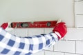 Process of tiling the tiles in the kitchen. Contractor measuring