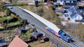 Process of transporting blades from huge wind turbines to wind farms for assembly Royalty Free Stock Photo