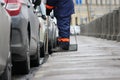 Process of urban street cleaning sweeping. Worker with broom and dust pan Royalty Free Stock Photo