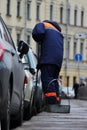 Process of urban street cleaning sweeping. Worker with broom and dust pan Royalty Free Stock Photo