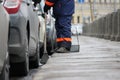 Process of urban street cleaning sweeping. Worker with broom and dust pan