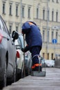 Process of urban street cleaning sweeping. Worker with broom and dust pan Royalty Free Stock Photo