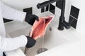 The process of washing and preparing a whole red trout for sale and cooking by the buyer, against the background of a black and Royalty Free Stock Photo
