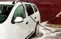 The process of washing a white car using a pressure washer