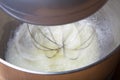 The process of whipping egg whites in a planetary mixer. Selective focus Royalty Free Stock Photo