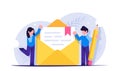 Process of writing a new letter. Email marketing concept. People stand near an envelope with a paper document. Modern Royalty Free Stock Photo