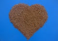 Processed heart grains of wheat on a blue background