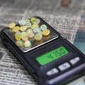 Processed opals stones on little weighing-machine