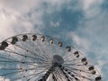 ferris wheel under clouds