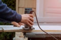 Processing carpenter with Electronic Plunge Router of wooden boards hand cutter close-up Royalty Free Stock Photo