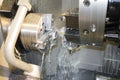 Processing detail on CNC lathe with coolant Royalty Free Stock Photo