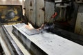 Processing and finishing of a metal plate on a surface grinding machine Royalty Free Stock Photo