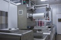 Processing of Packaging of butter and Cheese on food vacuum packaging sealing machine in food industrial factory. Packing food Royalty Free Stock Photo
