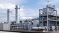 Processing unit with heat exchangers and chimneys at an industrial site under a partly cloudy sky Royalty Free Stock Photo