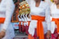 Procession of Balinese women in traditional sarongs carrying religious offering