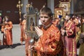 Procession in honor of the celebration of Russian Literature, a Young priest in Church vestments holding a flag with an Orthodox i