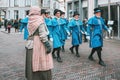 Procession of men dressed in blue Victorian costume during the Dickens Festival in Deventer