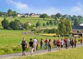 Procession to the Schnade in Brilon. Many hikers walk through the green landscape.